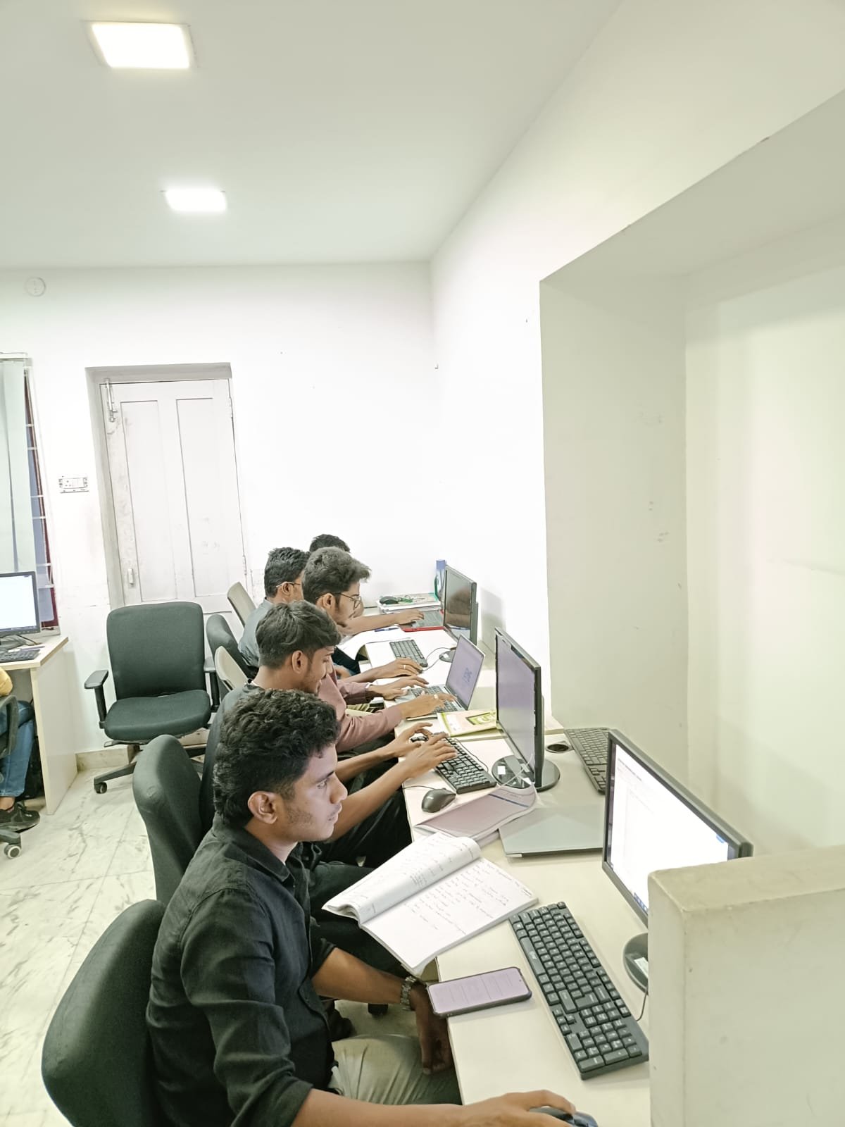 A row of students at a Techmaax centre following along with hands-on practice
