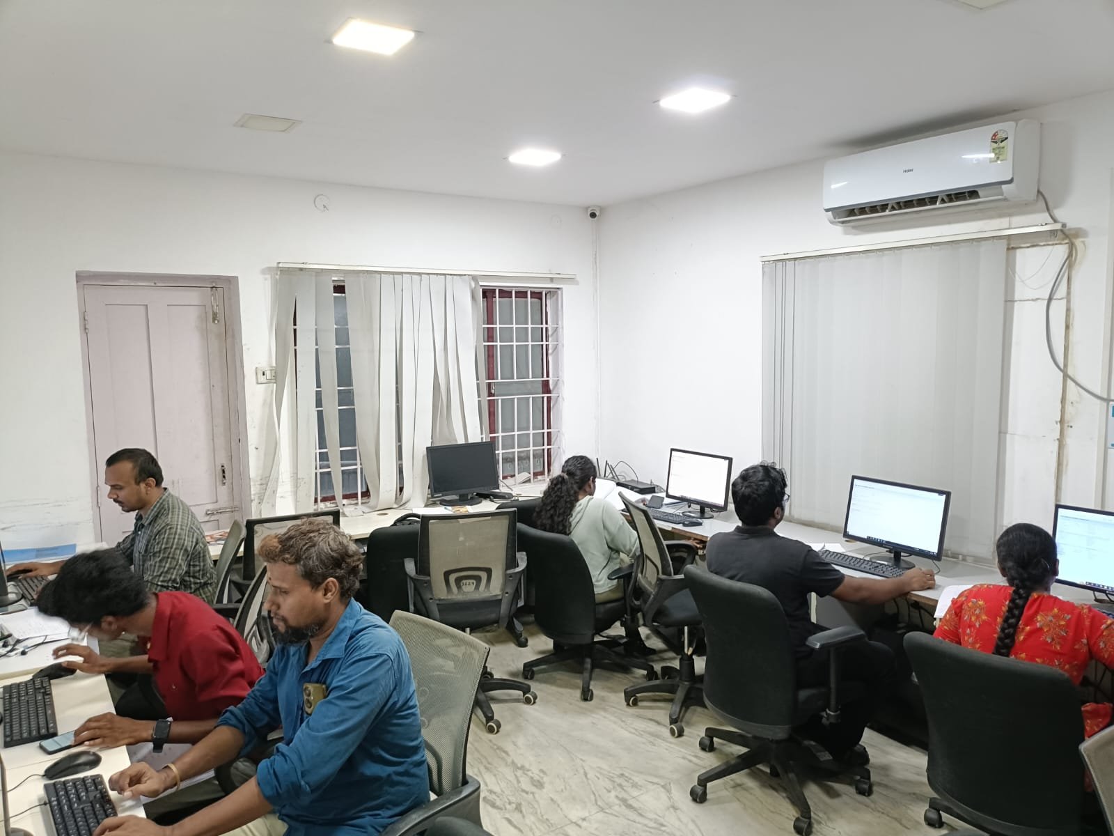 Students and staff working at desks in a Techmaax training centre