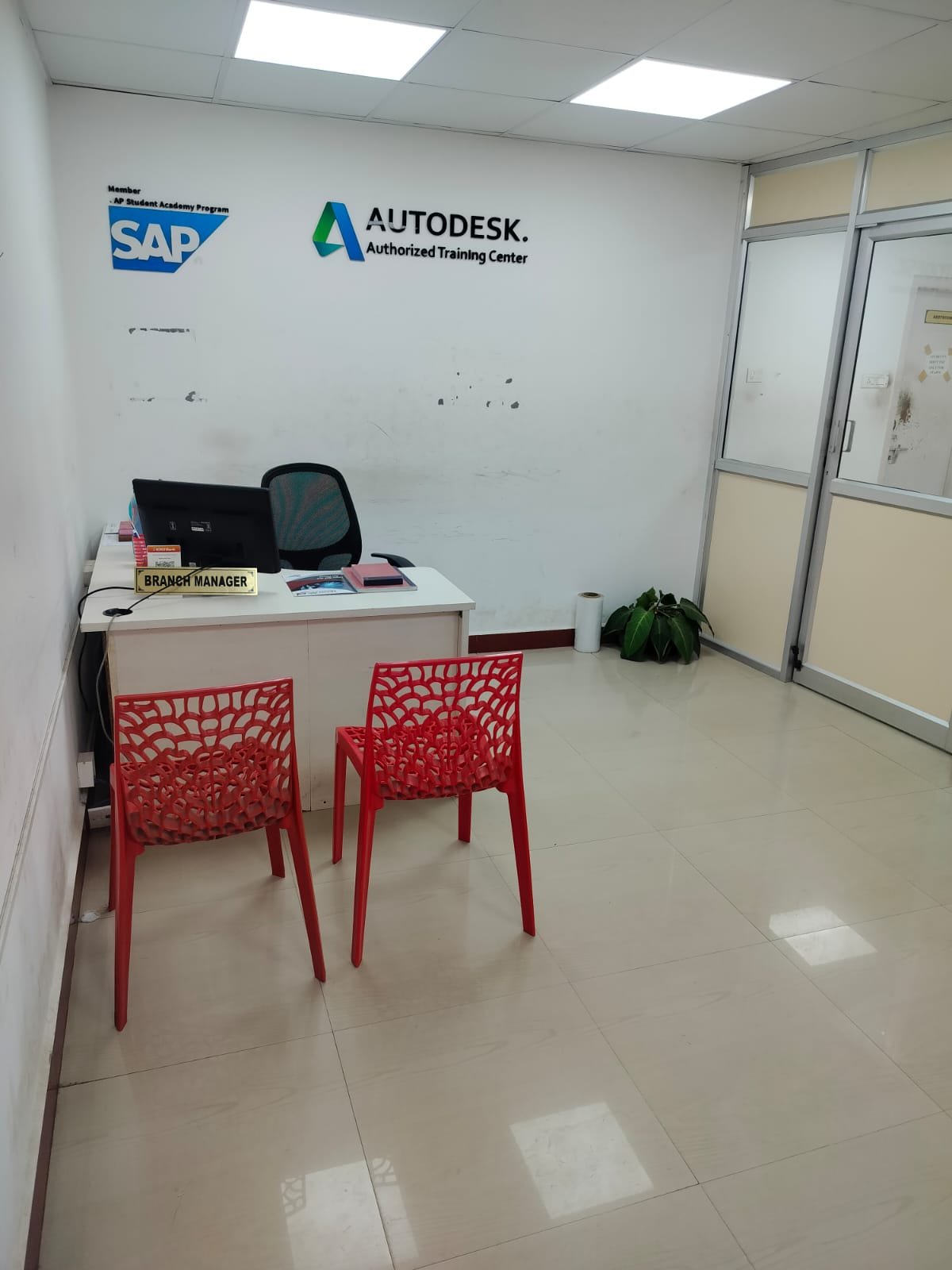 Branch Manager's desk at the Techmaax Velachery centre, with SAP and Autodesk Authorized Training Center signage