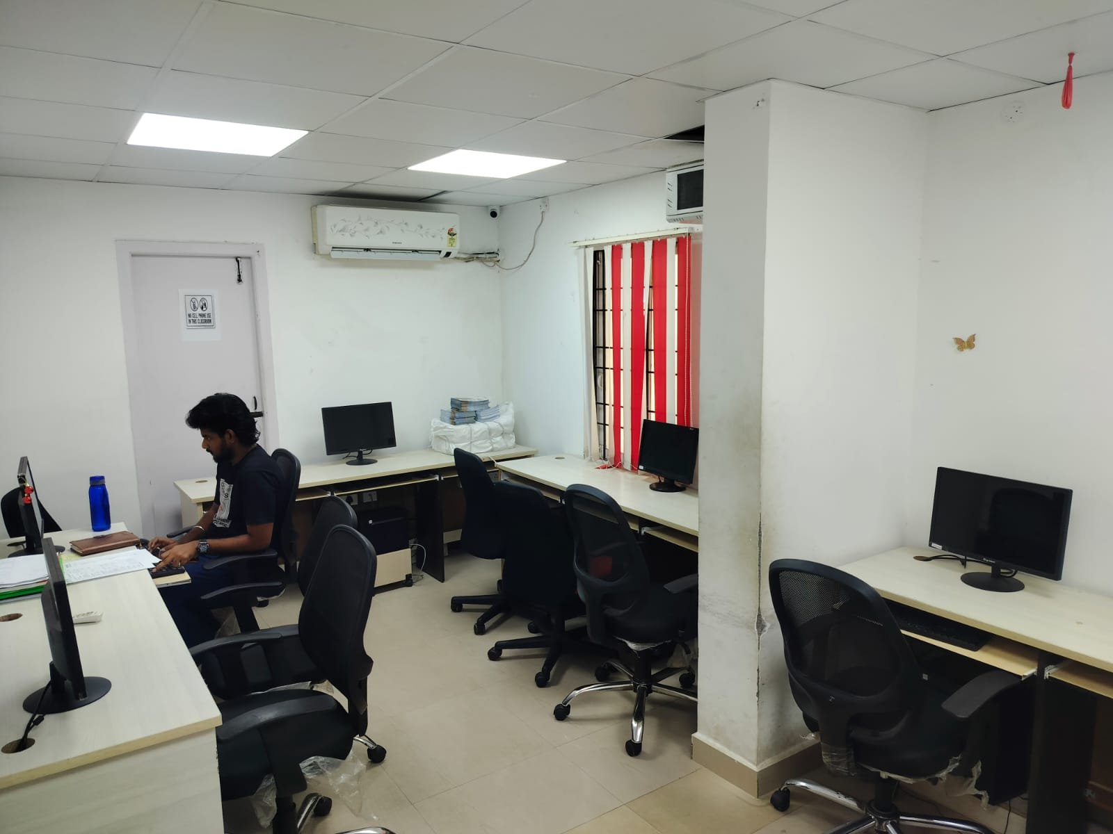 Staff working at a desk in the computer lab at Techmaax Velachery